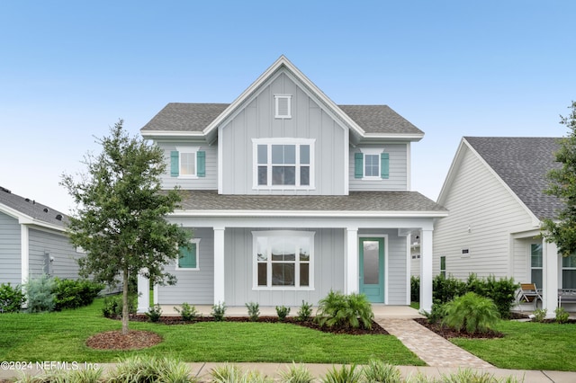 view of front of house featuring covered porch and a front lawn