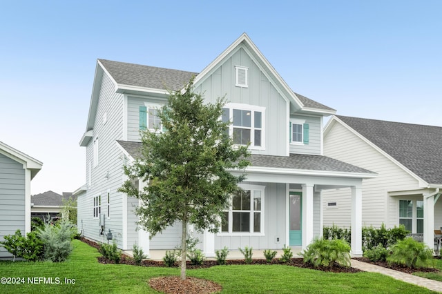 view of front of home featuring a front yard and covered porch