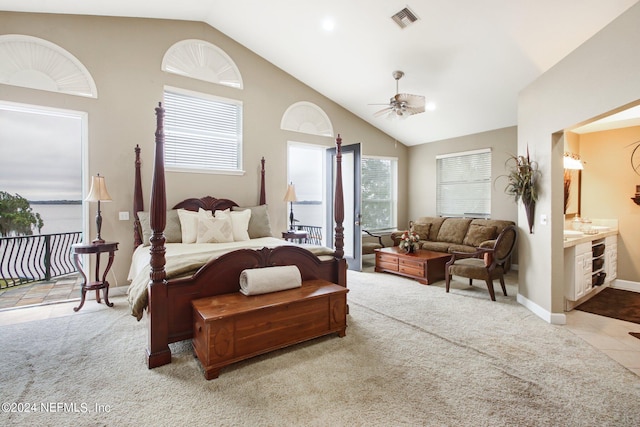 carpeted bedroom with ensuite bathroom, ceiling fan, and lofted ceiling