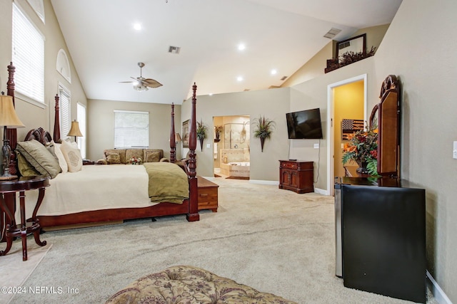 bedroom with ensuite bath, light carpet, ceiling fan, and vaulted ceiling