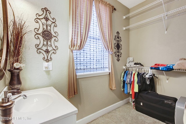 bathroom with vanity and baseboards