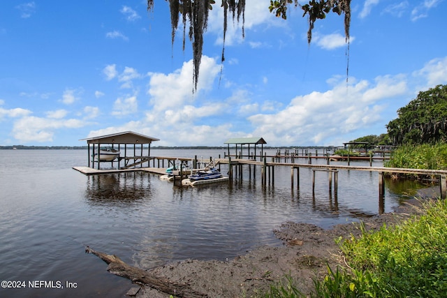 dock area with a water view and boat lift