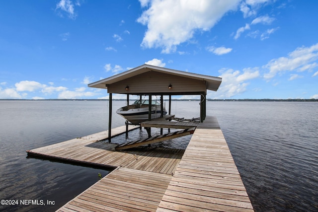 dock area with a water view and boat lift