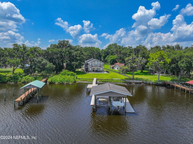 view of dock featuring a yard and a water view