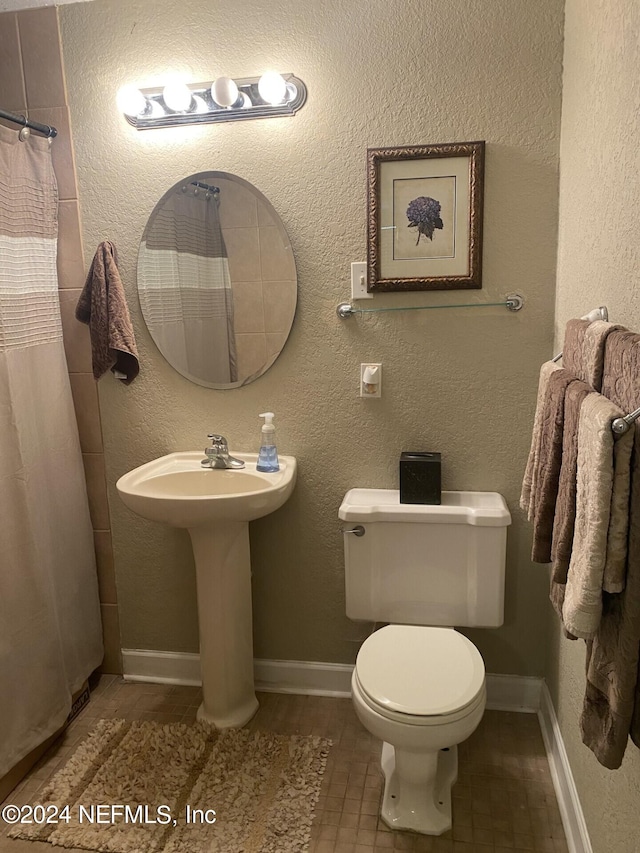 bathroom featuring tile patterned flooring and toilet