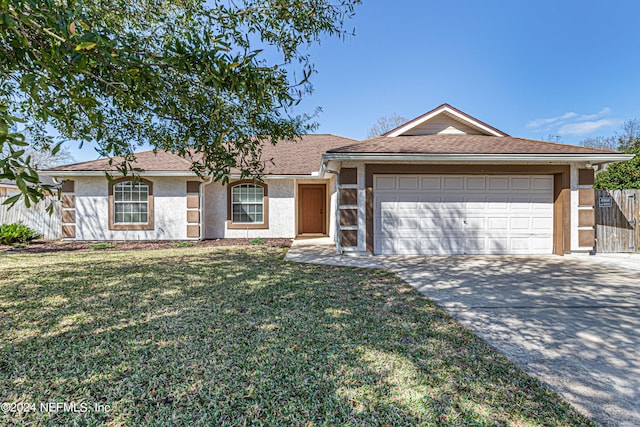 ranch-style house featuring a front lawn and a garage