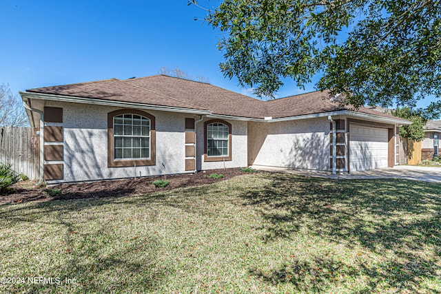 ranch-style home featuring a garage and a front lawn