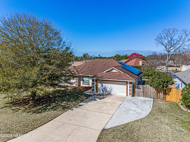 single story home with a garage and a front lawn