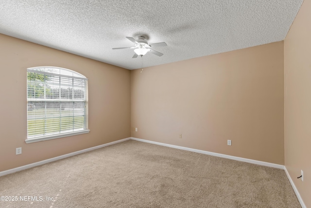 empty room with carpet flooring, a textured ceiling, and ceiling fan