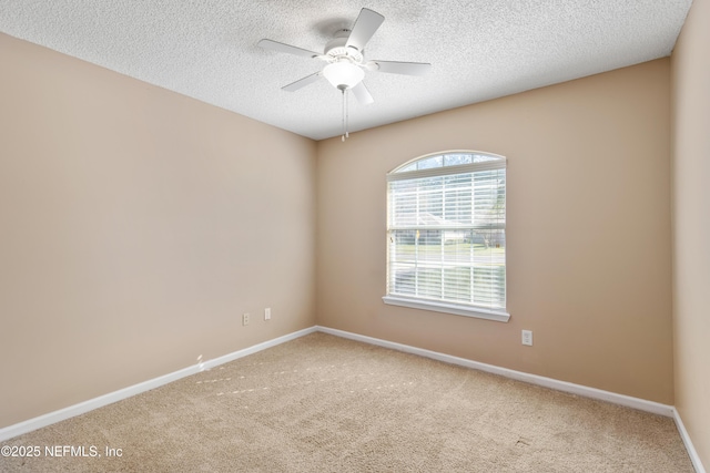 carpeted spare room with ceiling fan and a textured ceiling