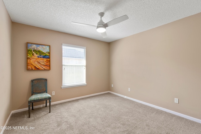 unfurnished room featuring a textured ceiling, carpet floors, and ceiling fan