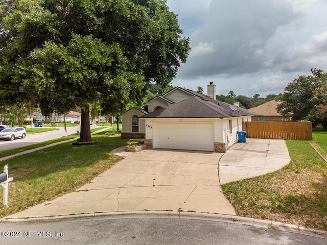 view of front of home with a garage and a front lawn