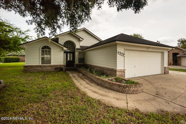 ranch-style home with a garage and a front yard