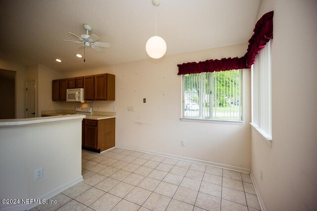 kitchen with light tile patterned flooring, ceiling fan, and decorative light fixtures