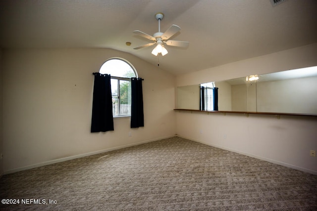 empty room with carpet floors, ceiling fan, and vaulted ceiling