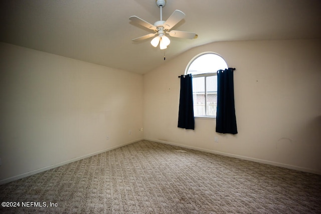 carpeted empty room with ceiling fan and vaulted ceiling