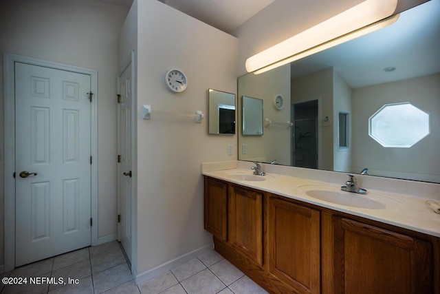 bathroom with tile patterned flooring, vanity, and walk in shower