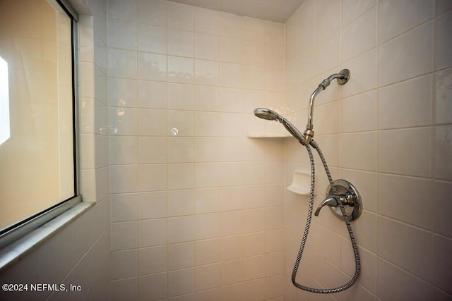 interior details featuring a tile shower