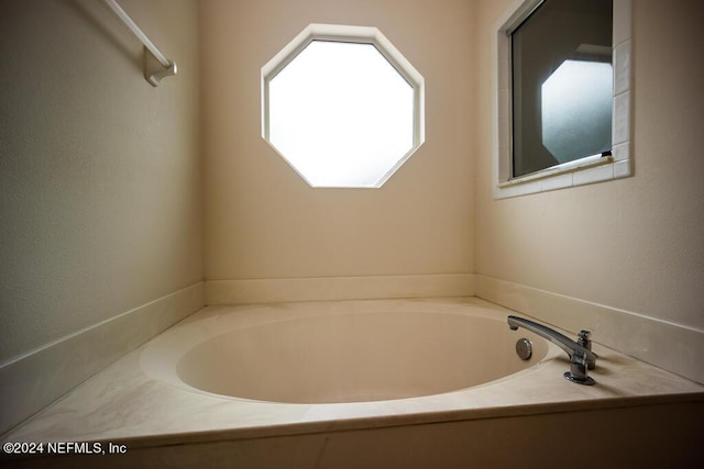 bathroom with a tub to relax in