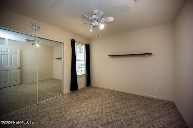 unfurnished bedroom with carpet, ceiling fan, and a closet