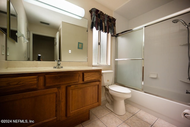 full bathroom with tile patterned floors, toilet, shower / bath combination with glass door, and vanity