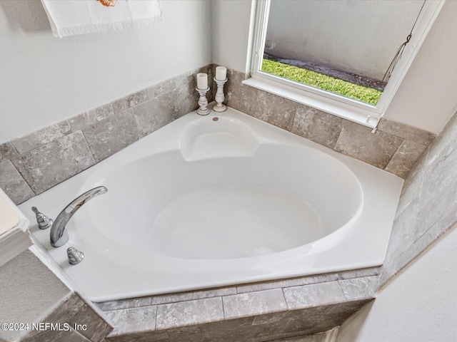 bathroom with tiled bath