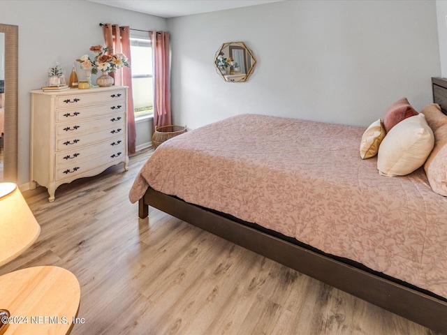 bedroom with wood-type flooring