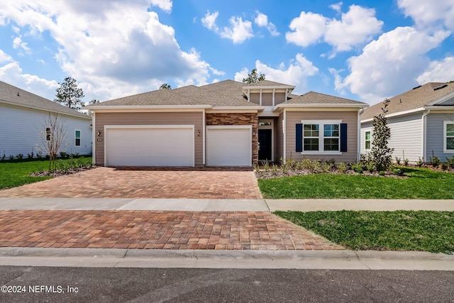 view of front of property with a front lawn and a garage