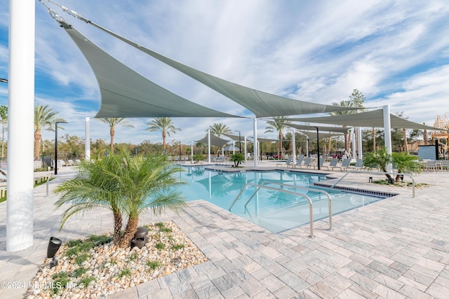 community pool with a patio area