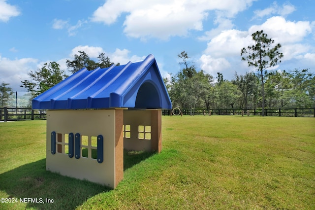 exterior space with fence and a yard