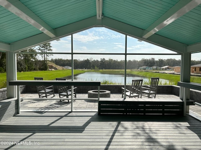 dock area with a yard, an outdoor fire pit, and a deck with water view