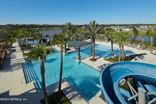 community pool featuring a water view and a residential view