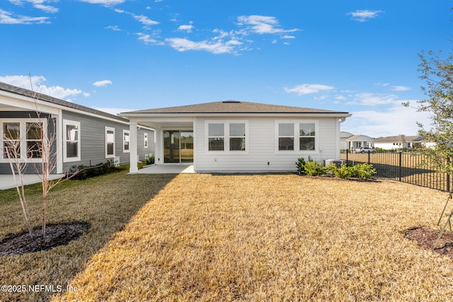 rear view of house with a patio, a yard, fence, and central air condition unit