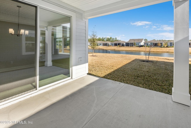 exterior space with a patio area, a water view, and a residential view