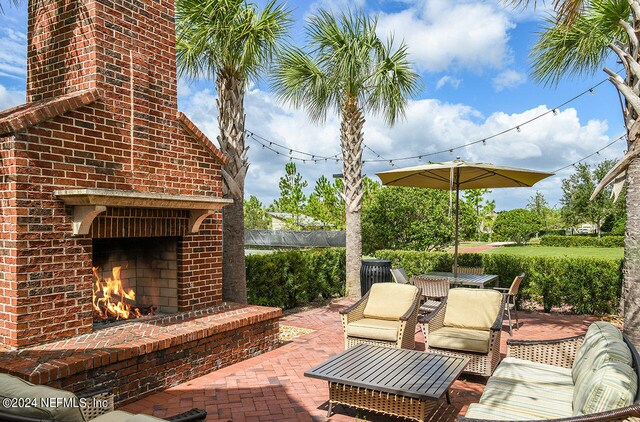 view of patio featuring an outdoor brick fireplace