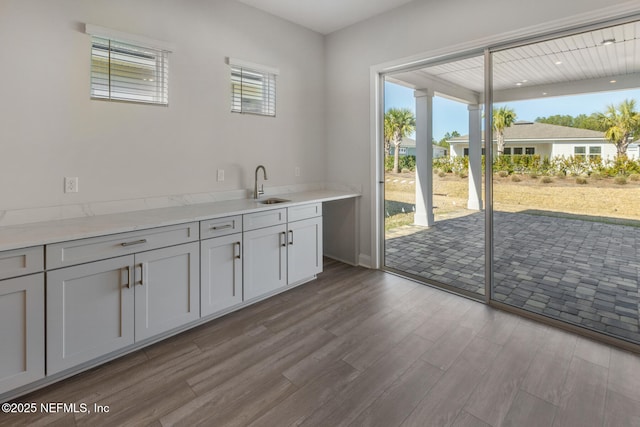 interior space with a sink, a wealth of natural light, and light wood-style floors