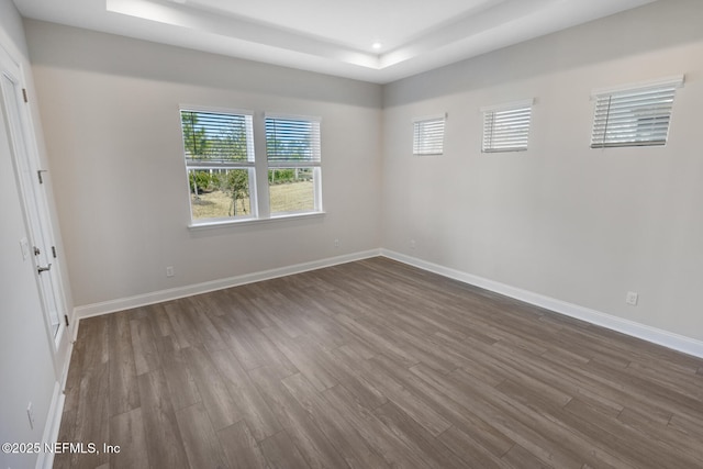 spare room with dark wood-style flooring, recessed lighting, and baseboards