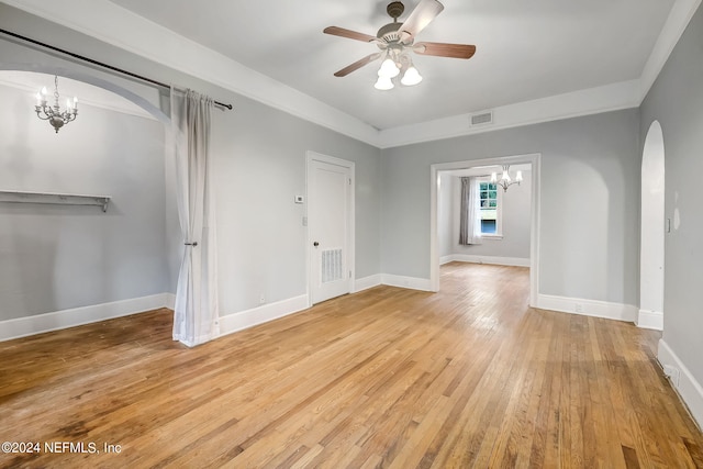 spare room featuring light hardwood / wood-style floors and ceiling fan with notable chandelier