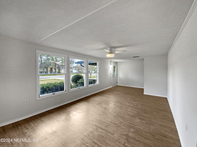 spare room featuring ceiling fan and dark hardwood / wood-style flooring