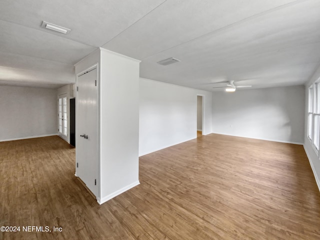 unfurnished room with wood-type flooring and ceiling fan