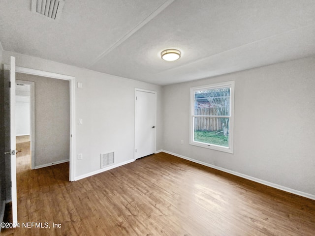 empty room with wood-type flooring