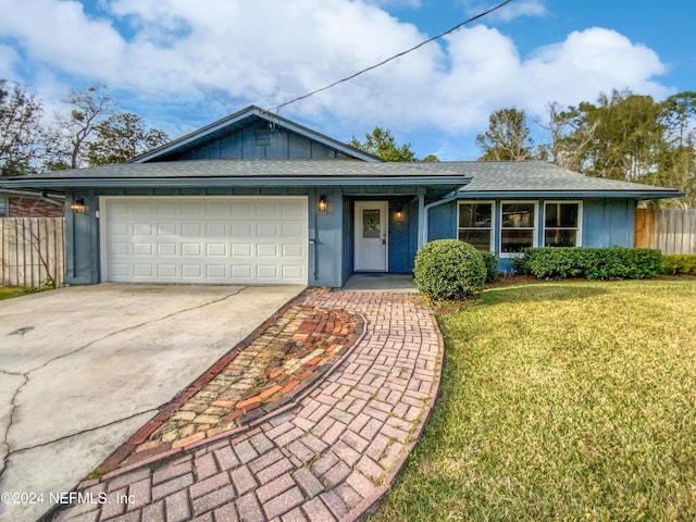 single story home with a garage and a front lawn