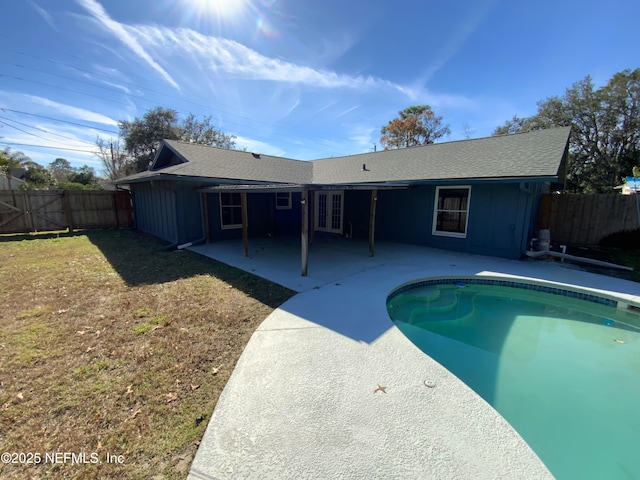 back of house featuring a fenced in pool and a patio area