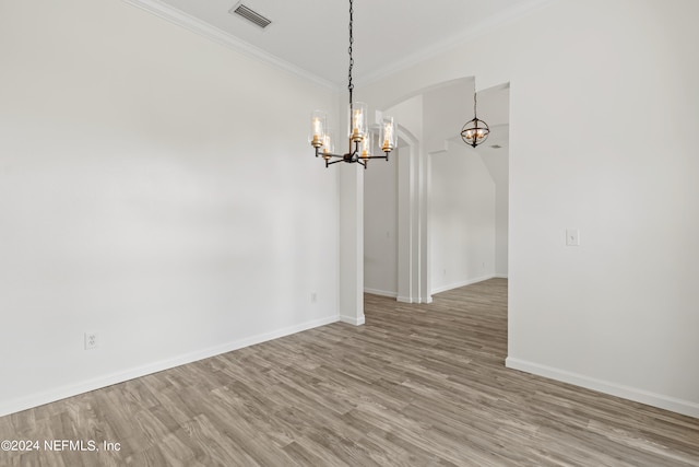 unfurnished room with ornamental molding and wood-type flooring