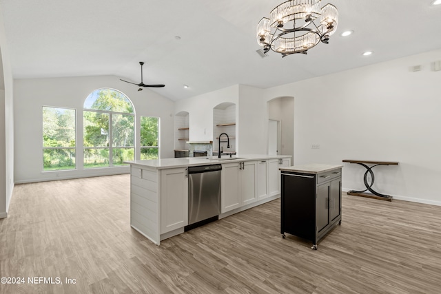 kitchen with sink, an island with sink, hanging light fixtures, stainless steel dishwasher, and white cabinets