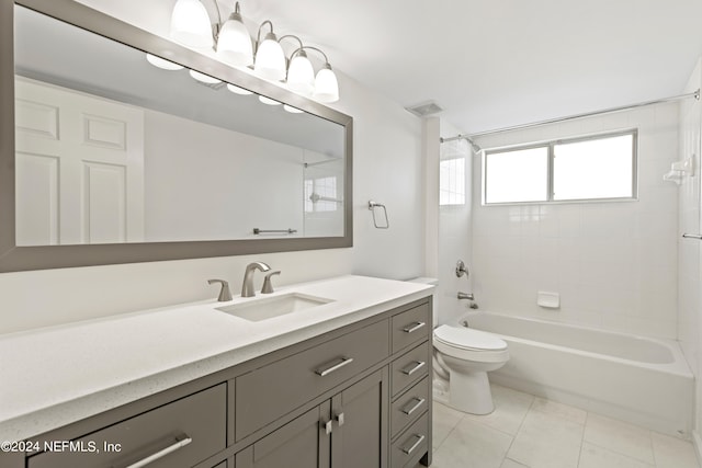 full bathroom with tiled shower / bath, vanity, toilet, and tile patterned floors