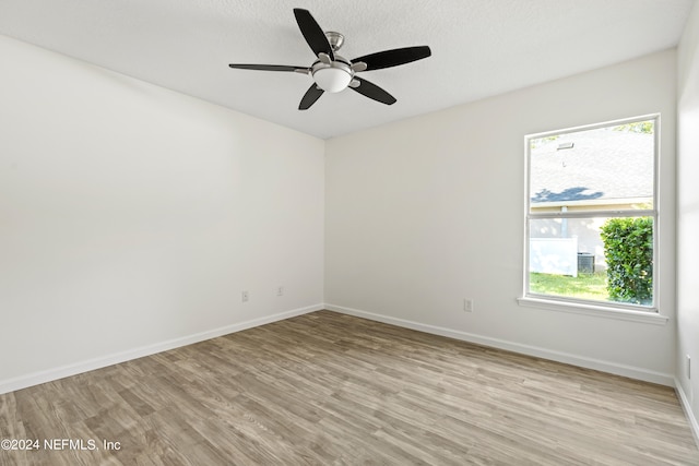 unfurnished room featuring light hardwood / wood-style floors, a textured ceiling, and ceiling fan