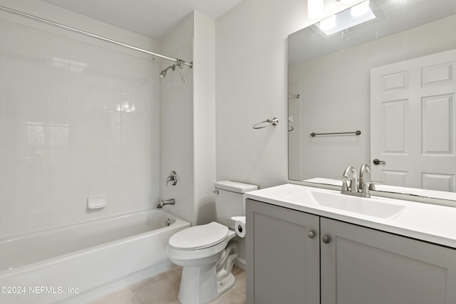 full bathroom featuring toilet, vanity,  shower combination, and tile patterned flooring