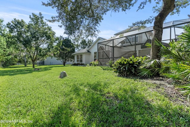 view of yard featuring glass enclosure