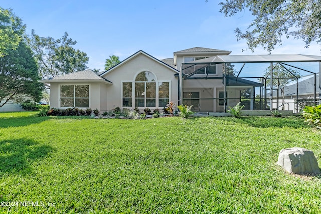 back of house with a lanai and a lawn